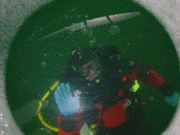Ice Diving | PADI Ice Diver Specialty | Diver enjoying the PADI Ice Diver Specialty Course at Square Lake near Stillwater, Minnesota. |  Looking through 2 feet of clear ice, not through a hole. | Photo: Scuba Center