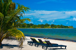 Relax in a beach chair at Los Porticos in Placencia, Belize | Experience the Barrier Reef of Belize with this Scuba Center group dive trip