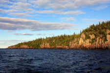 Isle Royale National Park | This wilderness archipelago is 45 miles long and nine miles wide at its widest point. Isle Royale National Park encompasses a total area of 850 square miles including submerged lands which extends four and a half miles out into Lake Superior. The archipelago is composed of many parallel ridges resulting from ancient lava flows which were tilted and glaciated. Isle Royale has 165 miles of scenic hiking trails and 36 campgrounds for backpackers and recreational boaters. There is excellent fishing, historic lighthouses and shipwrecks, ancient copper mining sites, and plenty of spots to observe wildlife. | Photo: James McKay, Scuba Center